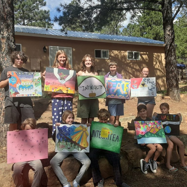 ten campers arranged in two rows, each holding a canvas painting with one of the Quaker "SPICES"
